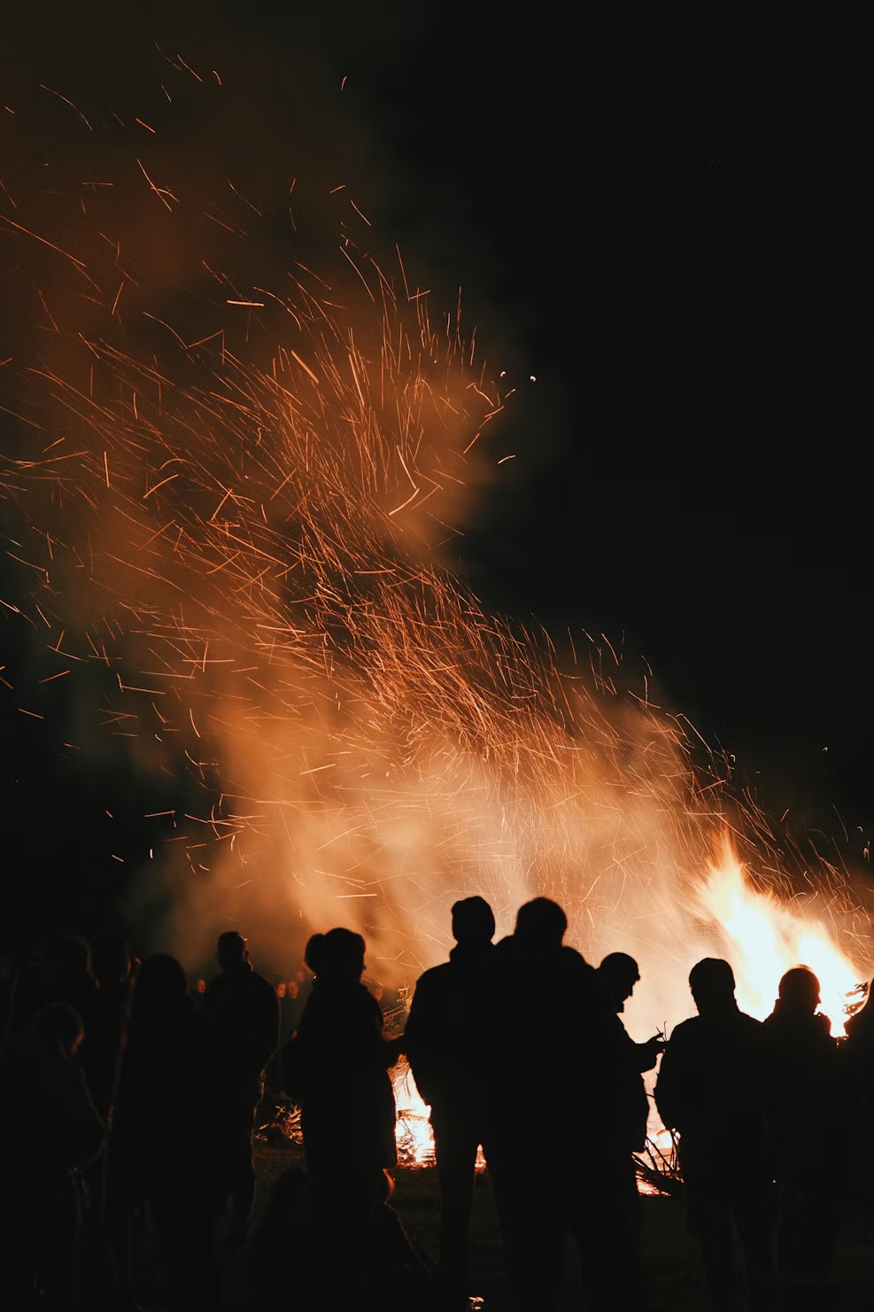 Guests gathered around a glowing bonfire