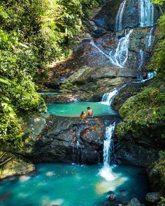 Cascading waterfall and turquoise pools amid lush greenery